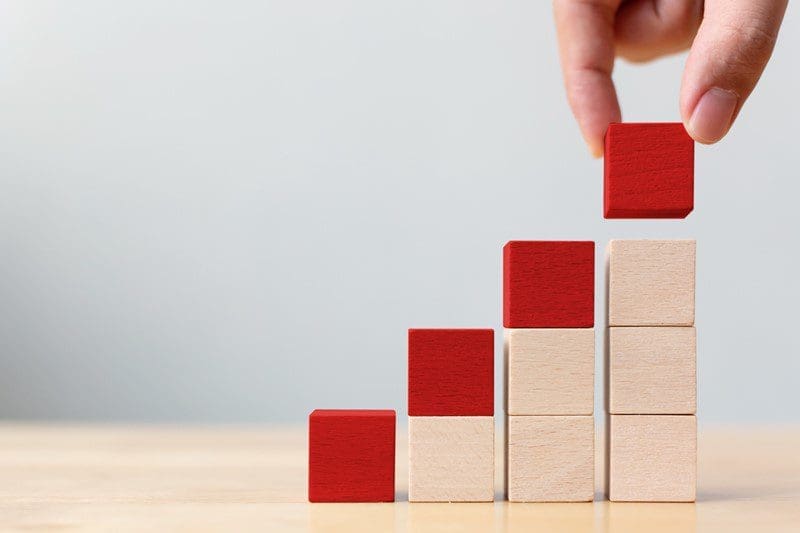 companies house filing fees increase represented by red building blocks getting higher and higher